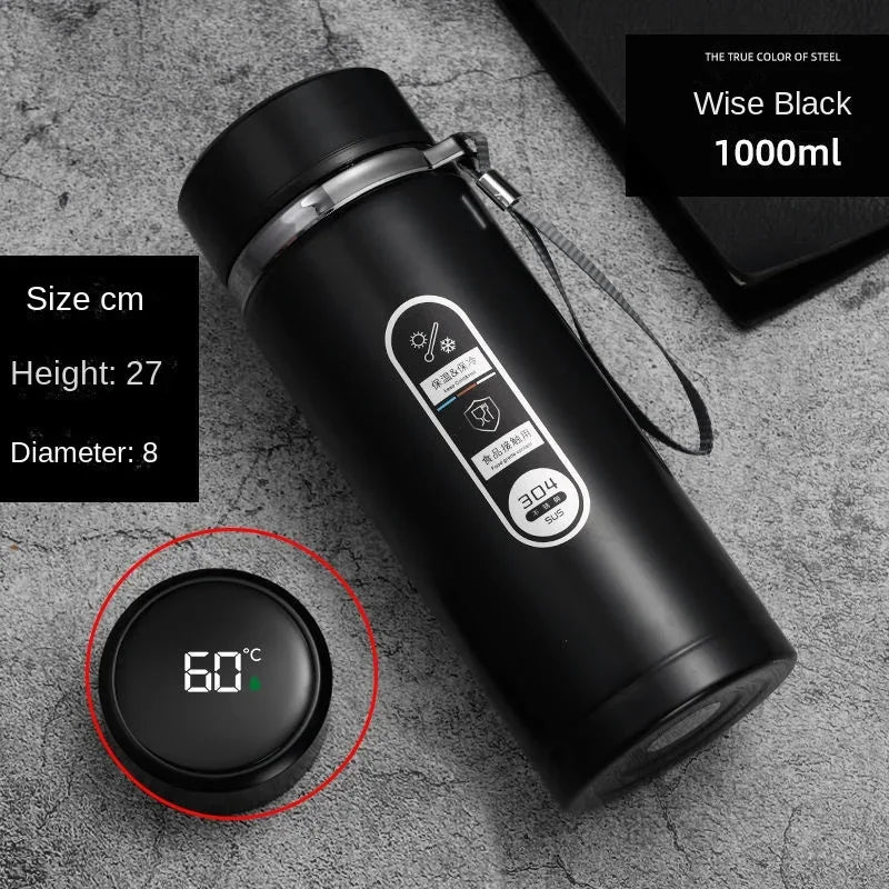 Black thermos bottle with digital temperature display on a gray surface