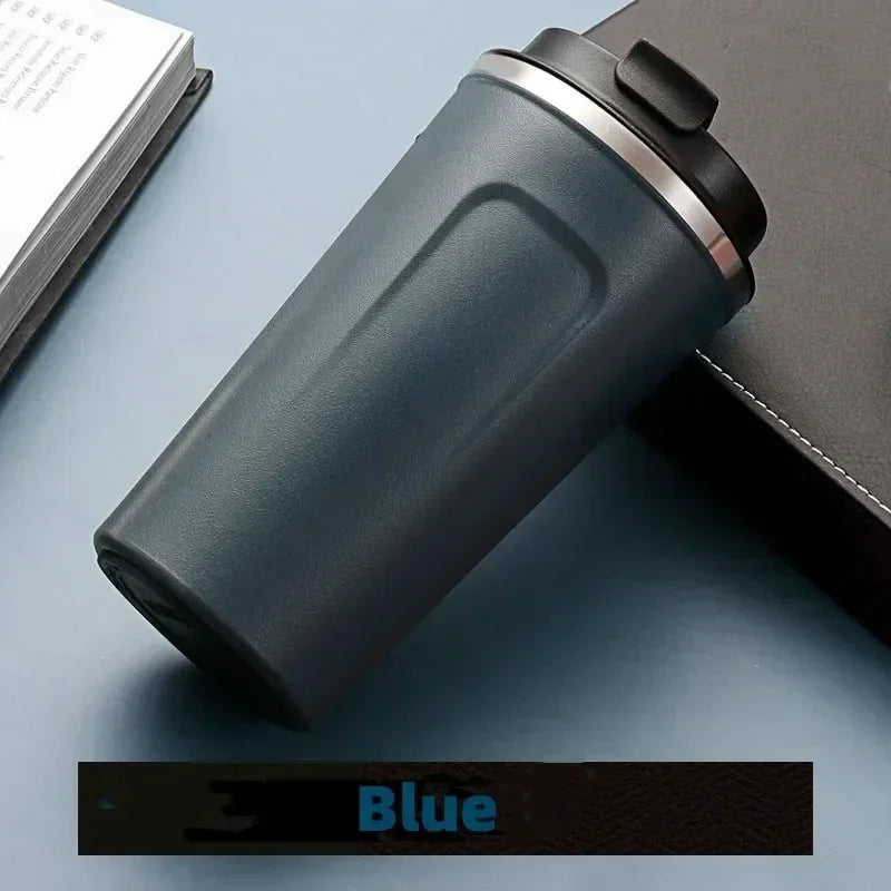 Blue tumbler on a gray surface with a blurred background