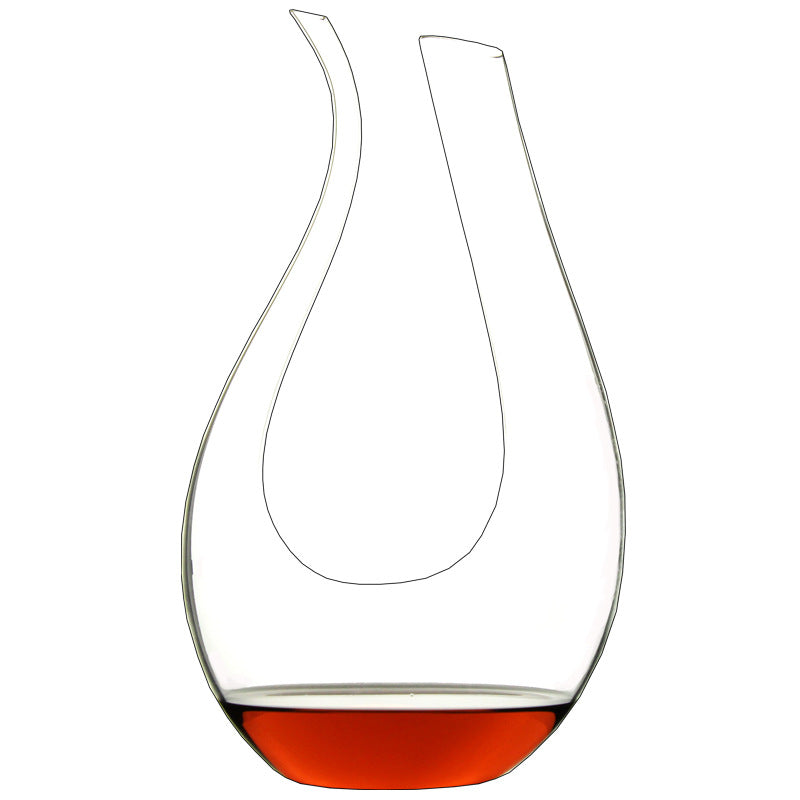 Clear wine decanter with red wine at the bottom on a white background