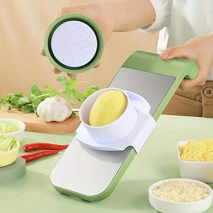 Person using a green and white kitchen tool to slice vegetables on a table with ingredients around.