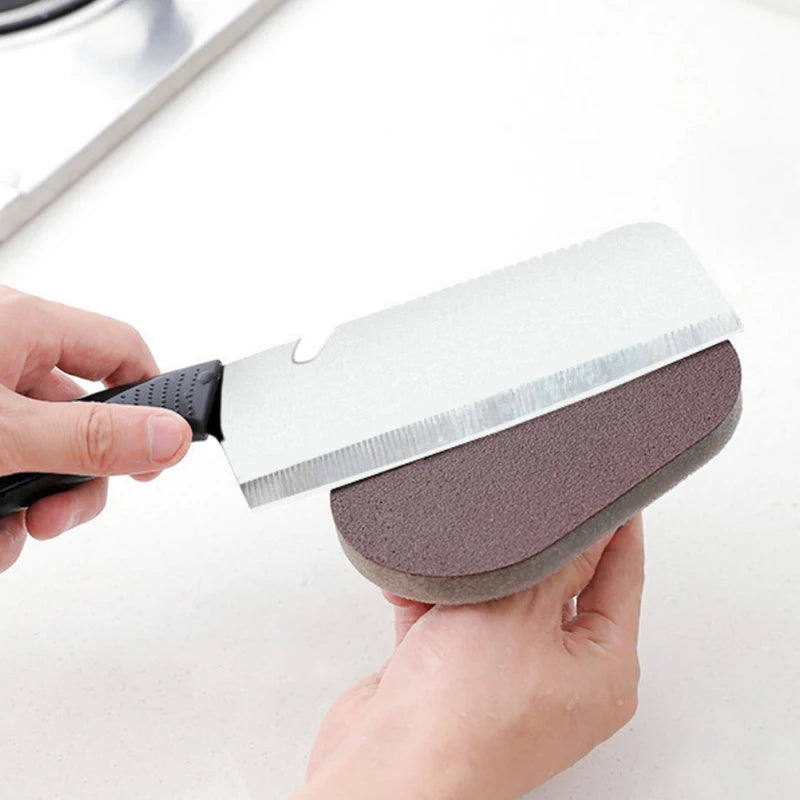 Person holding a knife with a sanding block attached on a white background