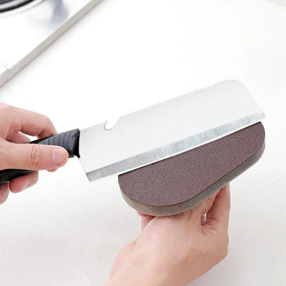 Person holding a knife with a sanding block attached on a white background