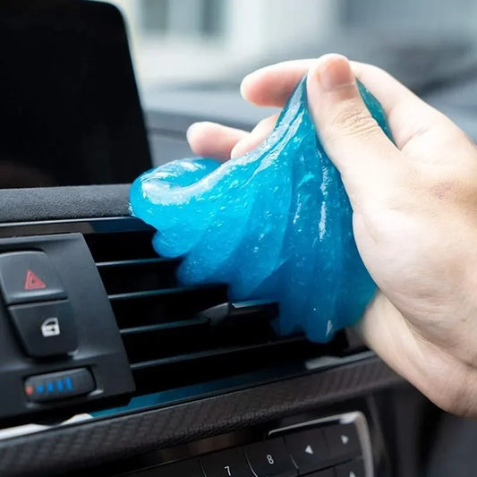 Hand using blue gel to clean car air vent