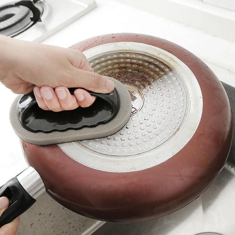 Person using a silicone trivet to handle a hot pan on a stove