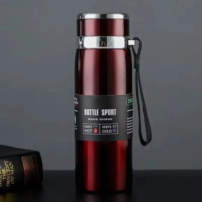 Red thermos bottle with a black label on a dark surface
