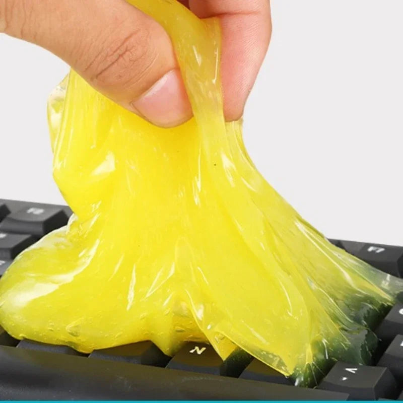Yellow putty being used to clean a keyboard
