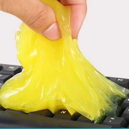 Yellow putty being used to clean a keyboard