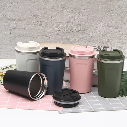 Set of five insulated travel mugs in different colors on a checkered surface.