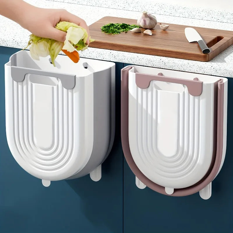 Two wall-mounted vegetable dryers on a kitchen counter with a hand using one of them.
