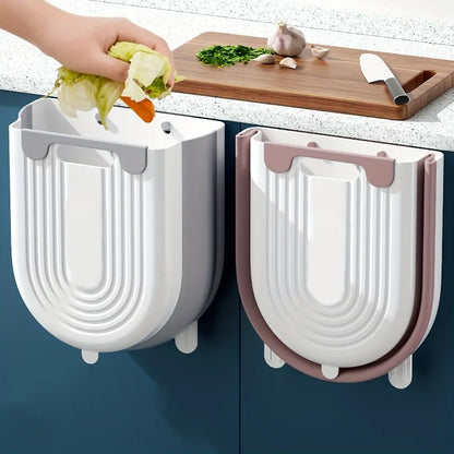 Two wall-mounted vegetable dryers on a kitchen counter with a hand using one of them.
