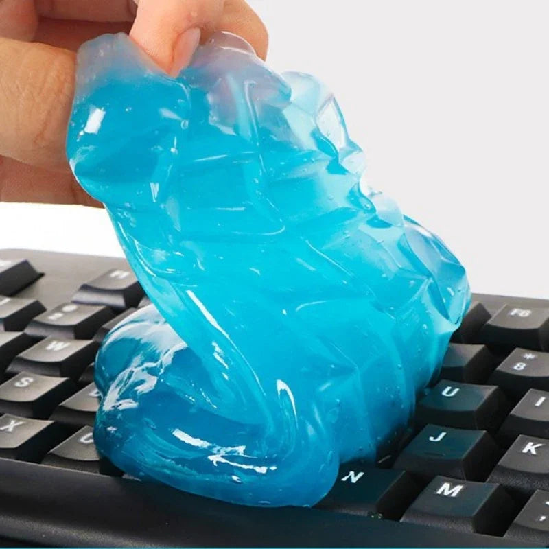 Blue putty being held above a keyboard