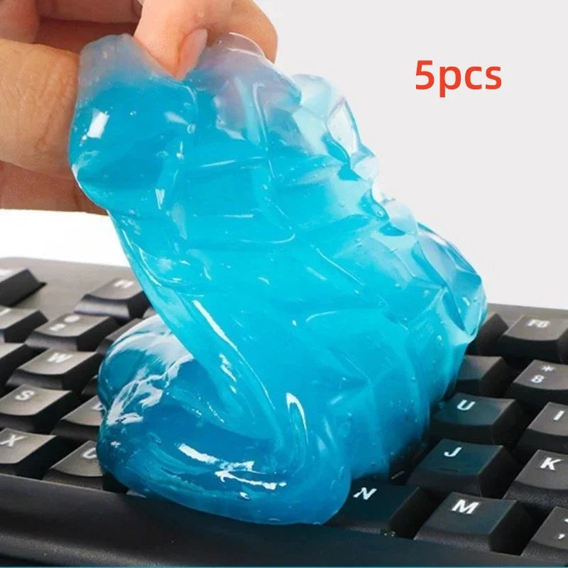 Blue putty being held above a keyboard with '5pcs' text in red.