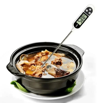 Digital thermometer inserted into a bowl of soup with visible temperature reading.