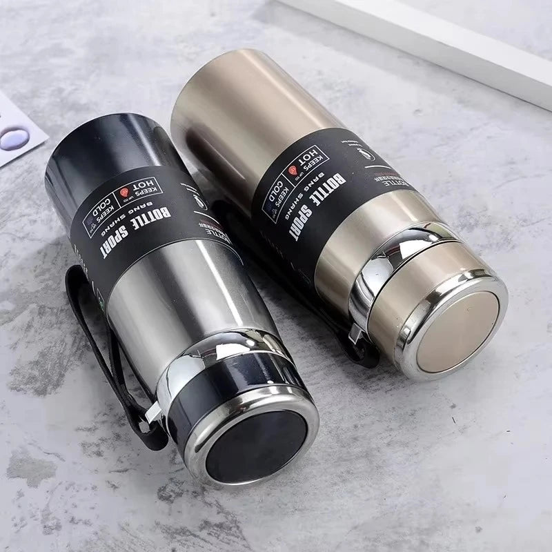 Two stainless steel thermos bottles on a textured surface