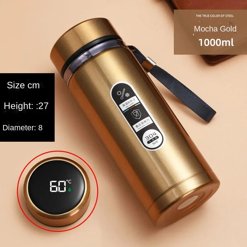 Gold insulated bottle with digital temperature display on a beige background