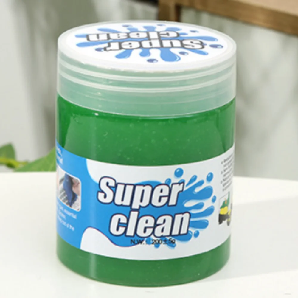 Green jar labeled 'Super Clean' on a white surface with a blurred background