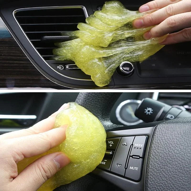 Cleaning a car's air vent with a yellow sponge.
